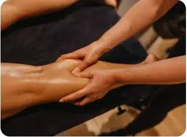 A person receiving a leg massage on a treatment table